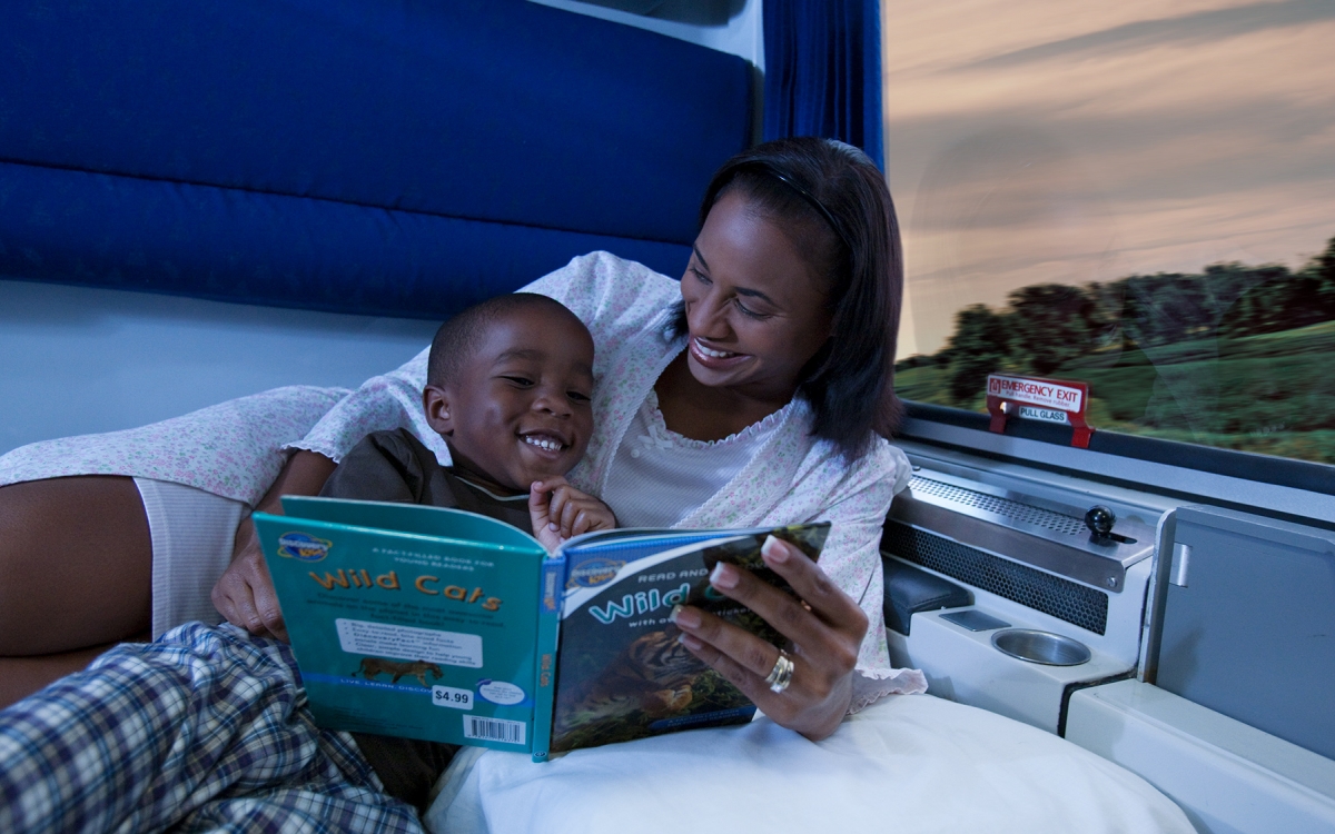 Family Bedroom mom and child reading book in private room onboard amtrak