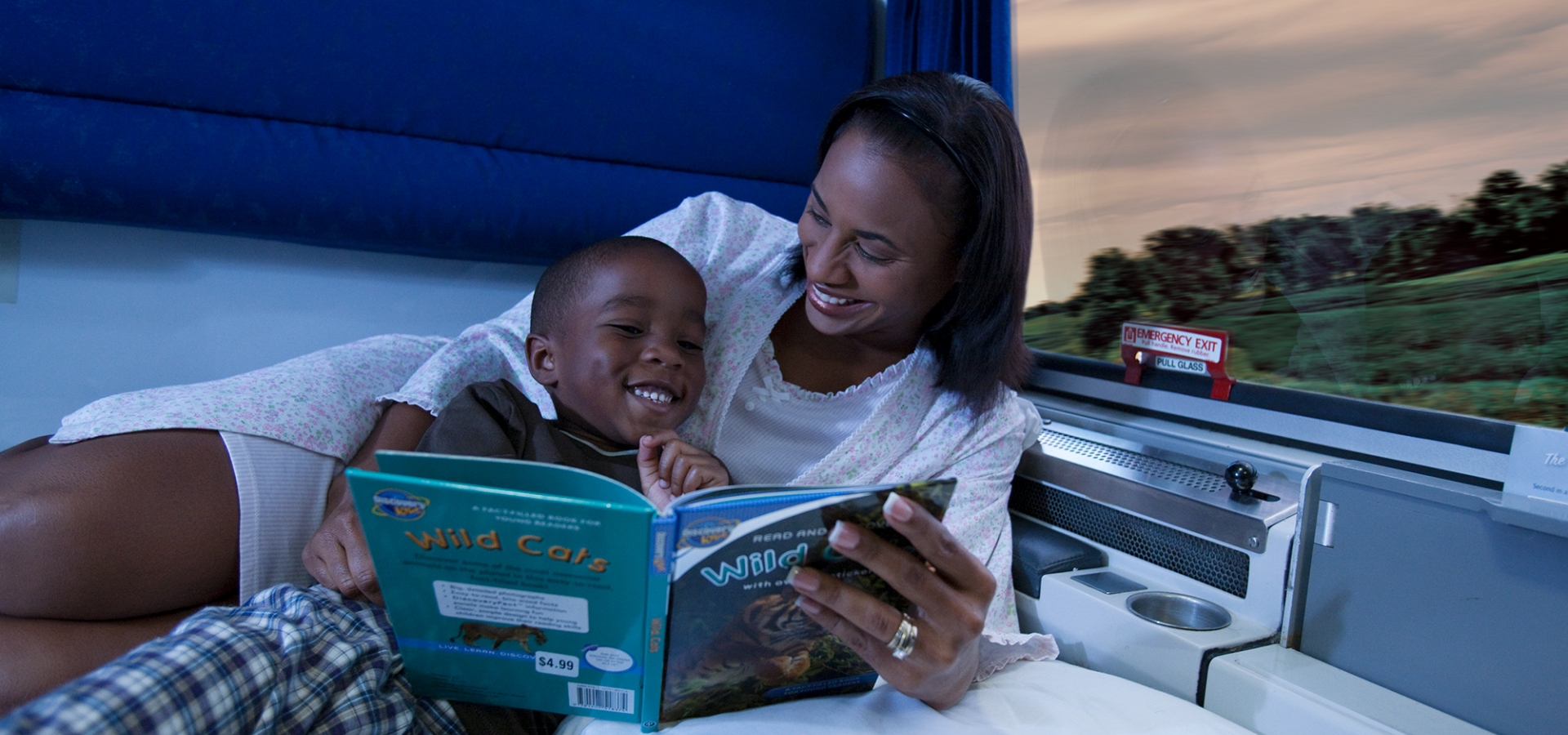 Family Bedroom mom and child reading book in private room onboard amtrak